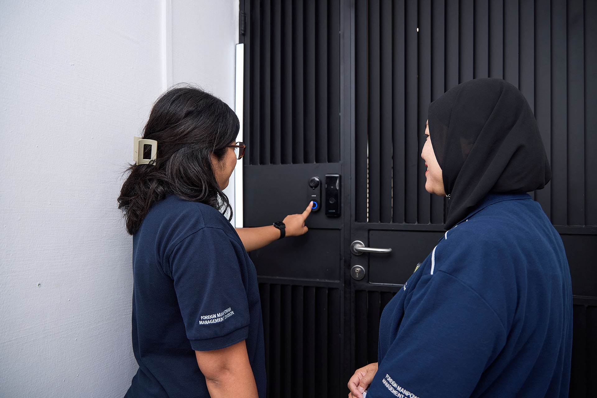 Officers ringing a doorbell